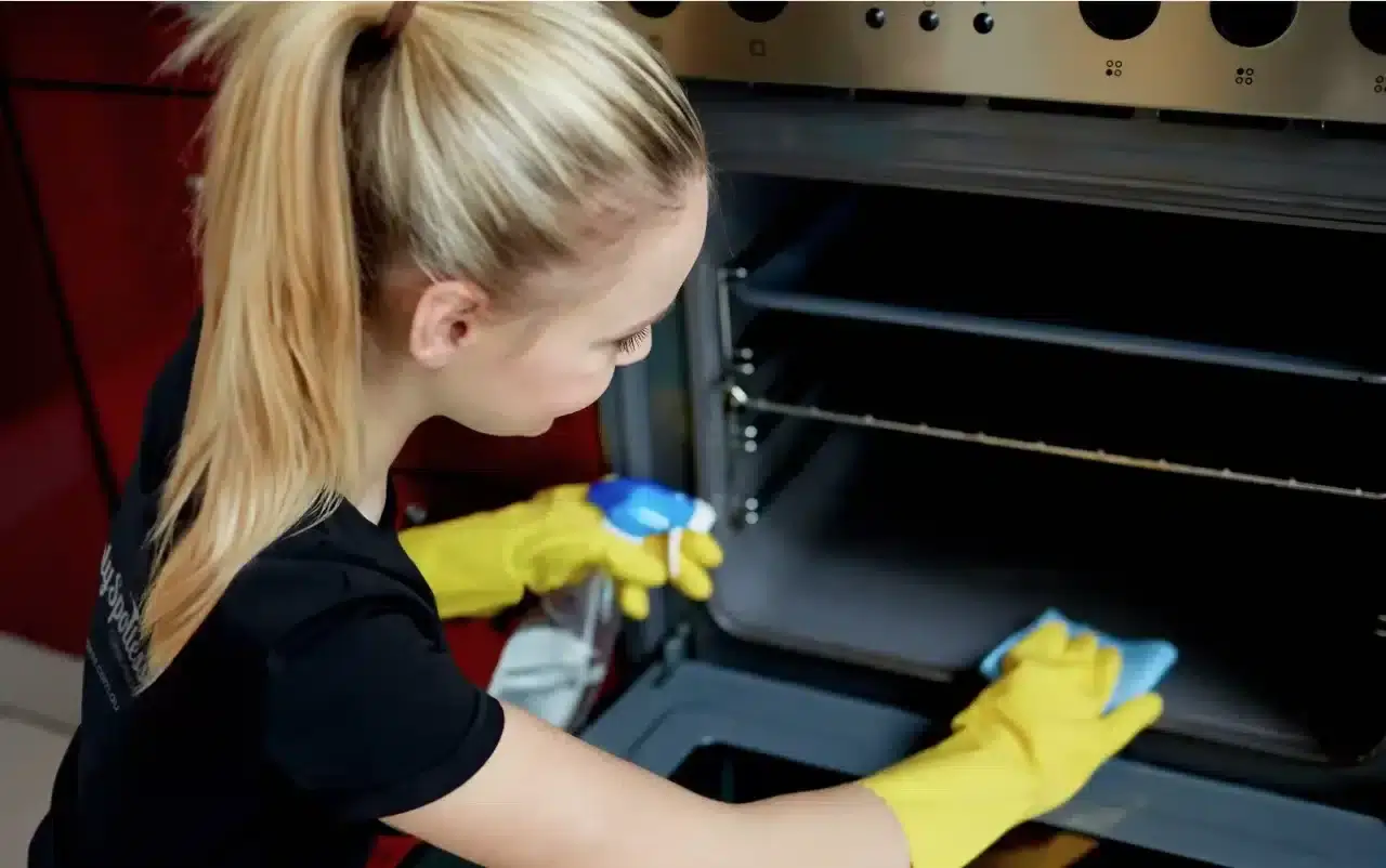 a woman cleaning an oven