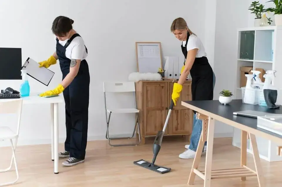 a man and woman cleaning a room